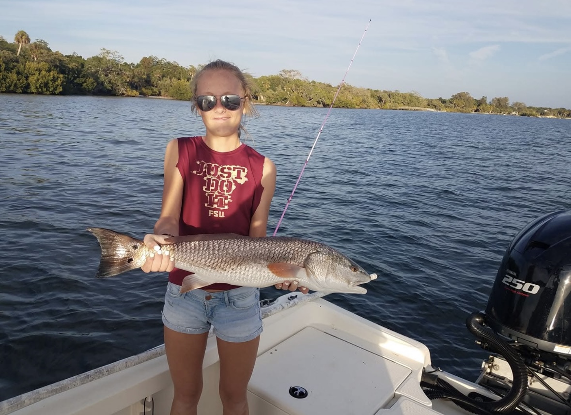 Successful summer family fishing charter in Bradenton showing variety of species caught